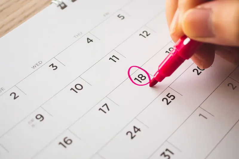 Female Hand With Pen Mark On Calendar Date Female Hand With Pen Mark On Calendar Date